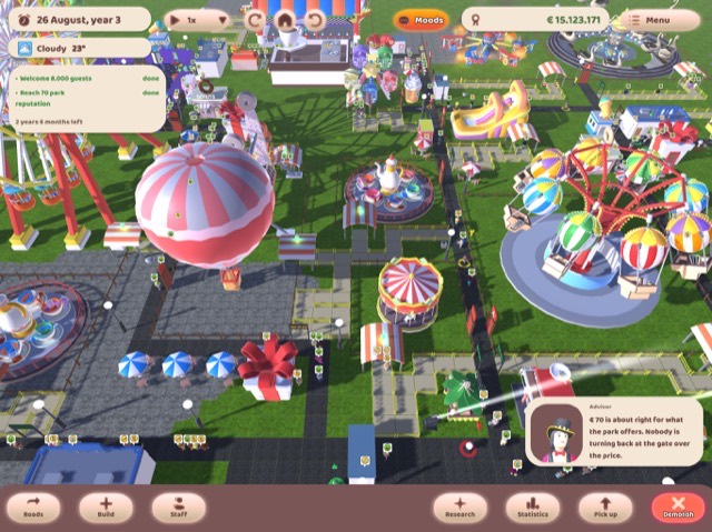 Screenshot of Amusement Factory, showing a theme park with rides and visitors